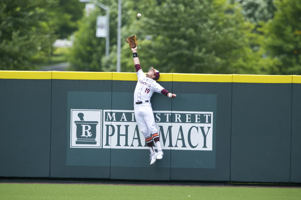 Virginia Tech's Gavin Cross cannot reach a home run by Oklahoma's Peyton Graham in the first inning of an NCAA college super regional baseball game Sunday, June 12, 2022, in Blacksburg, Va. (AP Photo/Scott P. Yates)