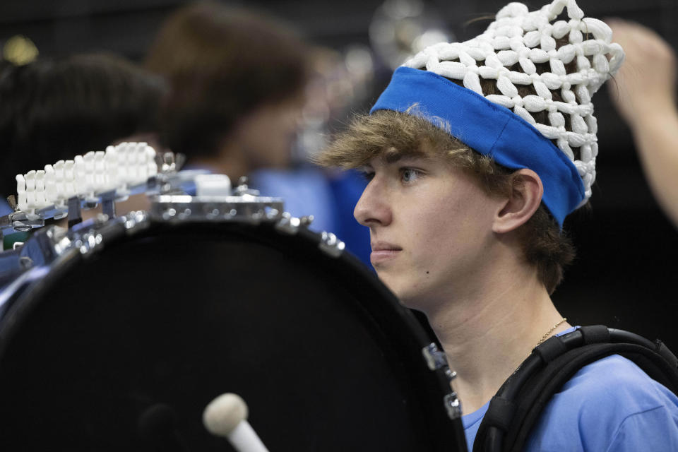 Seth Halsted, 17, a junior from Papillion-La Vista High School, plays the bass drum with the school's pep band before Alabama plays against Creighton in an NCAA college basketball game Saturday, Dec. 16, 2023, in Omaha, Neb. (AP Photo/Rebecca S. Gratz)