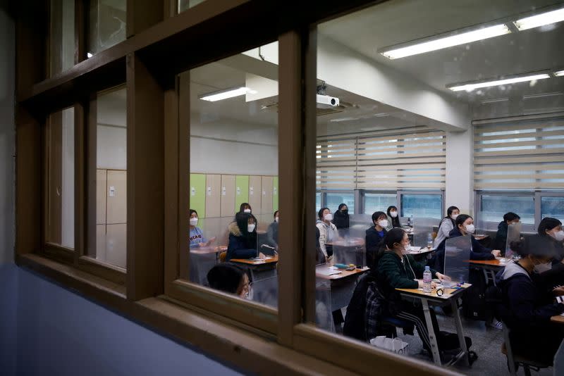 Students wait for the start of the annual college entrance examinations amid the coronavirus disease (COVID-19) pandemic at an exam hall in Seoul