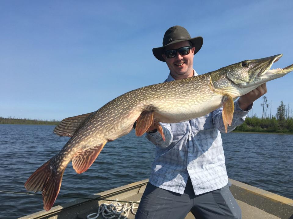Field & Stream editor-in-chief holds up a huge northern pike