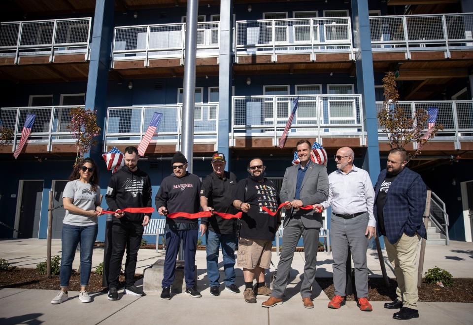 Four veterans cut the ribbon celebrating move-in day Courtney Place in downtown Salem.