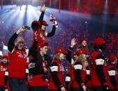 Canada's athletes wave as they arrive on stage in the closing ceremony for the Sochi 2014 Winter Olympic Games February 23, 2014. REUTERS/Marko Djurica (RUSSIA - Tags: OLYMPICS SPORT)
