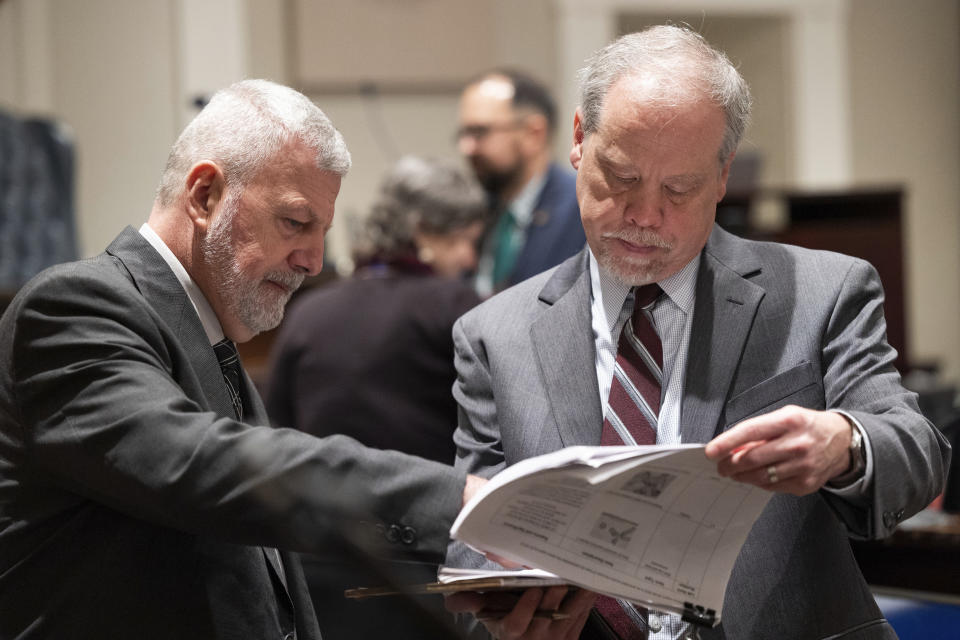 Prosecutor Creighton Waters prepares evidence with witness SLED senior special agent Jeff Croft before Alex Murdaugh's trial for murder resumes at the Colleton County Courthouse on Monday, Jan. 30, 2023. (Joshua Boucher/The State via AP, Pool)