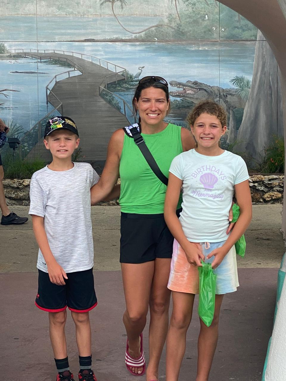 Cyrus Blakney, his mother, Racheal, and his sister, Piper, celebrate the twins' tenth birthday at Gatorland in Florida in July of 2022.