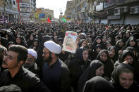 People attend a mass funeral for those who died in Saturday's terror attack on a military parade in the southwestern city of Ahvaz, that killed 25 people, in Ahvaz, Iran, Monday, Sept. 24, 2018. Thousands of mourners gathered at the Sarallah Mosque on Ahvaz's Taleghani junction, carrying caskets in the sweltering heat. (AP Photo/Ebrahim Noroozi)