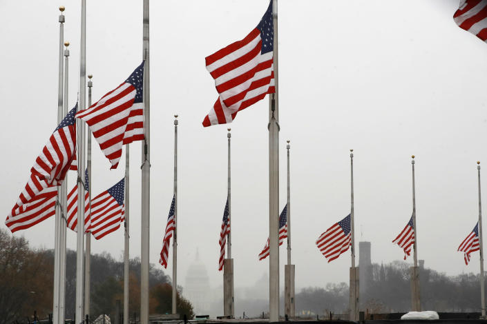 With a misty U.S. Capitol in the distance, the American flags surrounding the Washington Monument fly at half-staff on Dec. 1 in Washington, after President Trump directed that flags be flown at half-staff for 30 days to honor the memory of former President George H.W. Bush. (Photo: Jacquelyn Martin/AP)