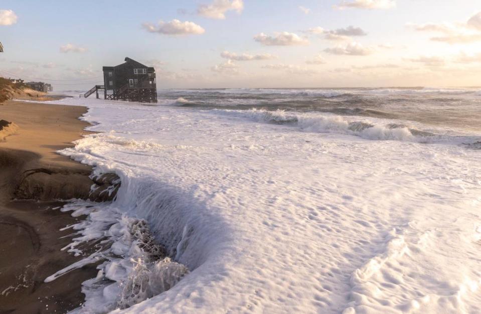 A home sits in the surf in Rodanthe Friday, Sept, 15, 2023 as Hurricane Lee churns in the Atlantic hundreds of miles offshore.