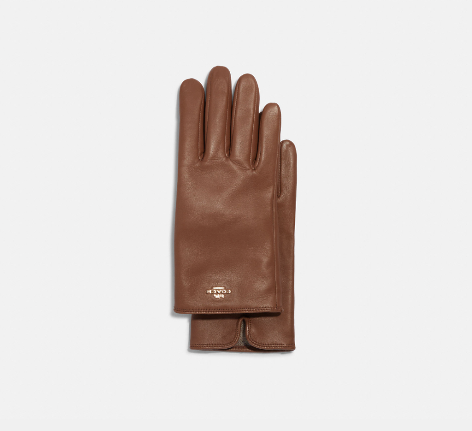 Coach Plaque Leather Tech Gloves in saddle (Photo via Coach Outlet)