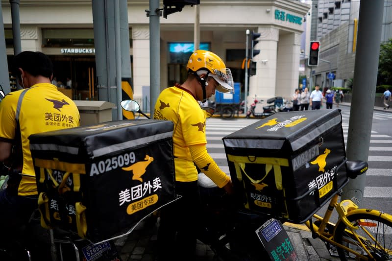 FILE PHOTO: Drivers of food delivery service Meituan are seen in Shanghai