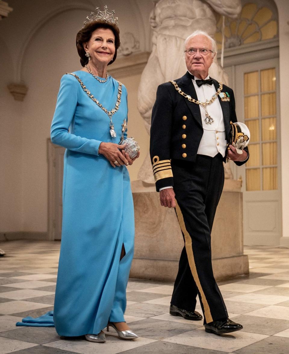 the king and queen walking together