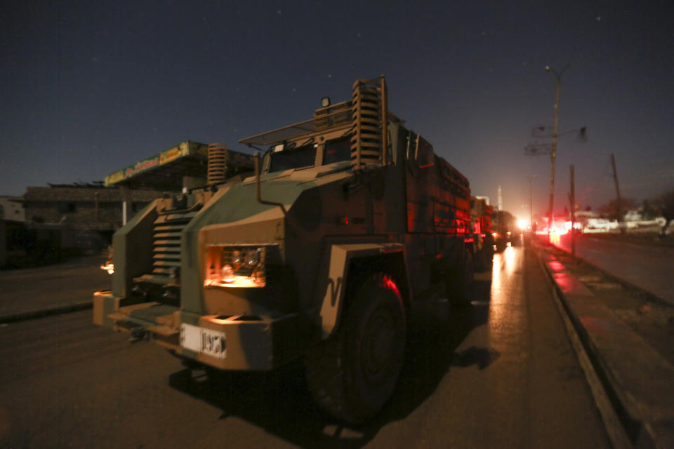 Turkish military convoy drives in Idlib province, Syria, Friday, Feb. 7, 2020. Several Turkish armored vehicles and tanks entered rebel-controlled northwestern Syria early on Friday, the latest reinforcements sent in by Ankara amid a Syrian government offensive that this week brought the two countries' troops into a rare direct confrontation. (AP Photo/Ghaith Alsayed)