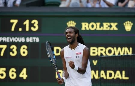 Dustin Brown of Germany celebrates after breaking serve in fourth set during his match against Rafael Nadal of Spain at the Wimbledon Tennis Championships in London, July 2, 2015. REUTERS/Stefan Wermuth