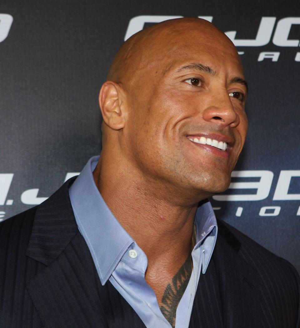 Dwayne Johnson smiling at a publicity shoot