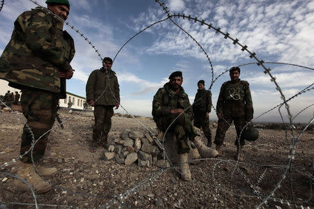 Afghan national army soldiers stand at their outpost at Shembawut village in Khowst province December 14, 2009. REUTERS/Zohra Bensemra