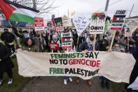 Pro-Palestinian demonstrators march during a visit by President Joe Biden in Warren, Mich., Thursday, Feb. 1, 2024. (AP Photo/Paul Sancya)