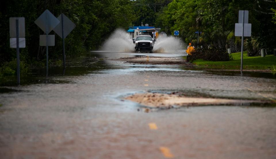 A truck splashes along a flooded Bailey Rd. Saturday, June 4, 2022. Flooded roads and areas were visible along parts of Sanibel Island as rains from a tropical disturbance dropped over 11Ó of rain overnight.