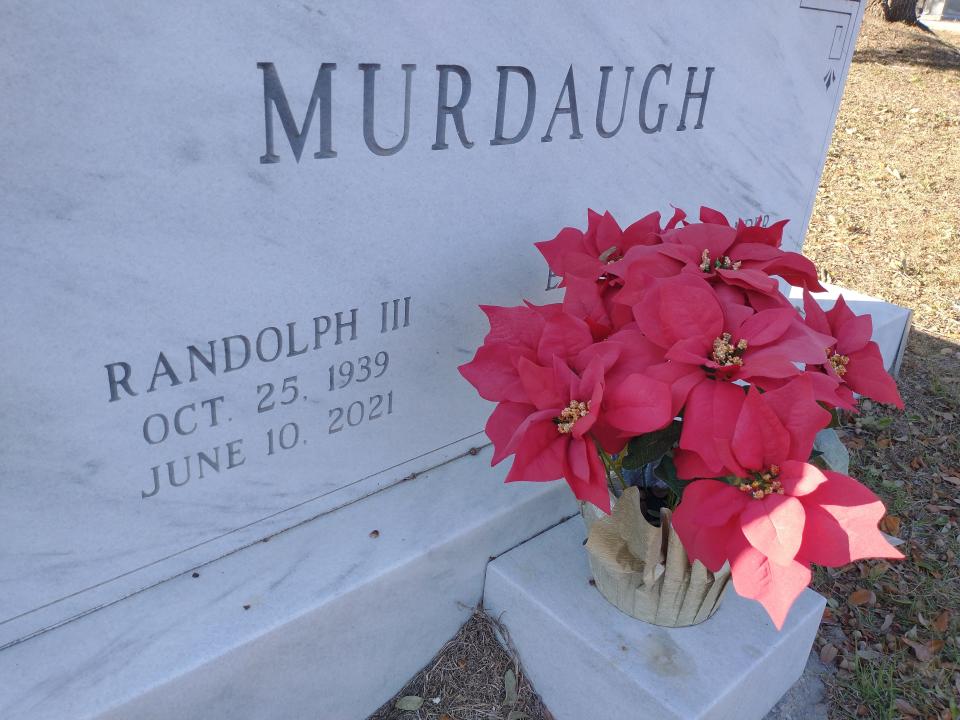 A Poinsettia has been placed at the headstone of Randolph Murdaugh III, former 14th Circuit Solicitor, at the Murdaugh family's final resting place in the Hampton Cemetery.
