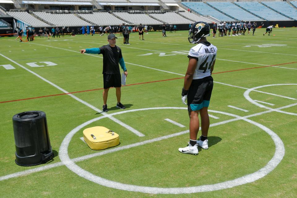 Jaguars first round draft pick (44) OLB Travon Walker works on technique with outside linebackers coach Bill Shuey Friday afternoon during Rookie Minicamp. The Jacksonville Jaguars held their first Rookie Minicamp on the turf of TIAA Bank Field Friday afternoon, May 13, 2022. Among those in attendance were the team's 2022 draft picks. [Bob Self/Florida Times-Union]