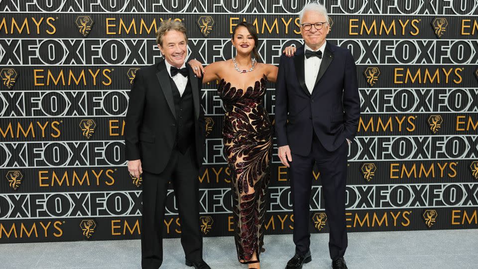 Martin Short and Steve Martin pose either side of their “Only Murders in the Building” co-star Selena Gomez, who wore Oscar de la Renta. - Neilson Barnard/Getty Images