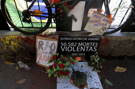 A bicycle is displayed by members of the NGO Rio de Paz (Rio of Peace) in the area where a cyclist was killed last month, as a form of protest against violence, at the Rodrigo de Freitas lagoon in Rio de Janeiro, Brazil, June 18, 2015. REUTERS/Sergio Moraes