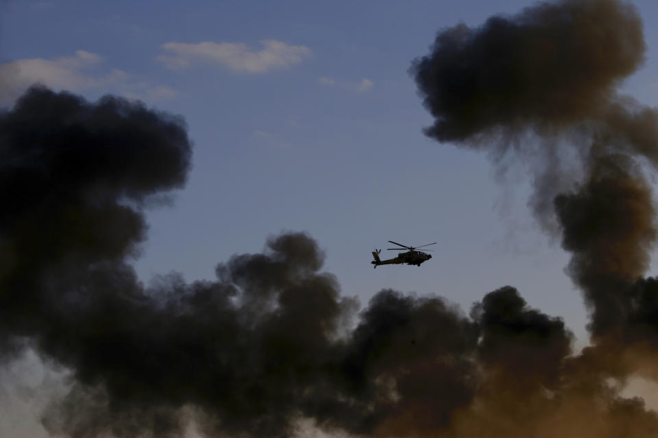 An Israeli Air Force Apache attack helicopter flies during a graduation ceremony for new pilots in the Hatzerim air force base near the city of Beersheba, Israel, Wednesday, Dec. 26, 2018. (AP Photo/Ariel Schalit)