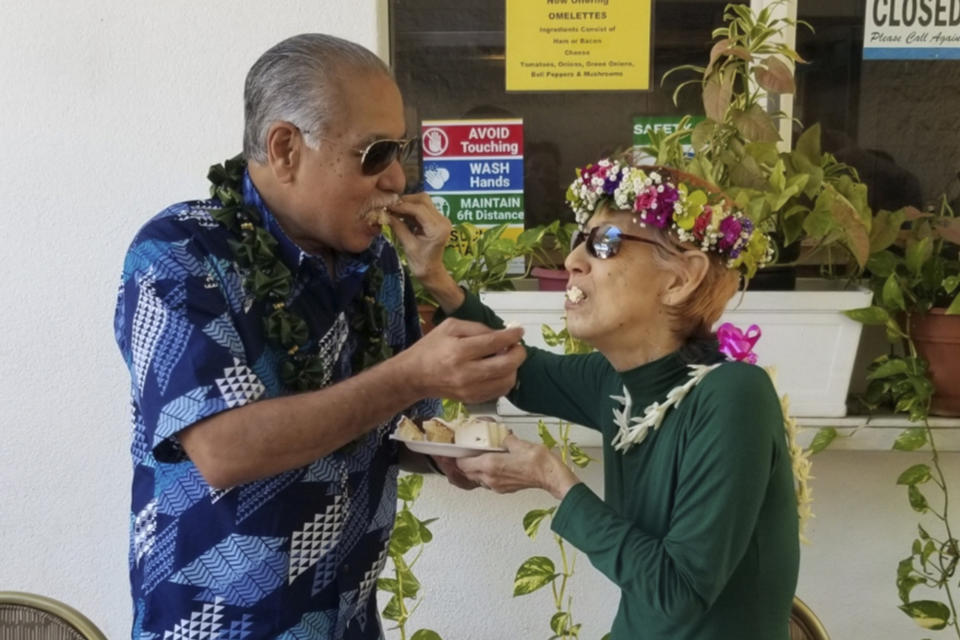 In this photo provided by Lorine Lopes, Weslee Chinen, left, and Sharlene Rabang are shown at their wedding ceremony, Aug. 7, 2021, in Lahaina, Hawaii. Honolulu's medical examiner said a contributing cause of her death was the thick, black smoke that Rabang breathed as she fled. The report made Rabang the 100th victim of the deadliest U.S. wildfire in more than a century. (Lorine Lopes via AP)