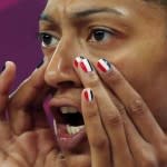 France's Emmeline Ndongue has her finger nails painted in the French flag colors as she yells from the bench during the women's preliminary round Group B basketball match against Australia at the Basketball Arena during the London 2012 Olympic Games