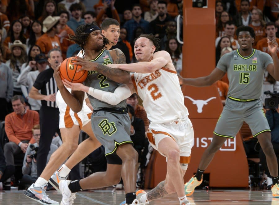 Baylor guard Jayden Nunn, left, tries to protect the ball from Texas guard Chendall Weaver, right, during the second half of an NCAA college basketball game, Saturday, Jan. 20, 2024, in Austin, Texas. Texas won 75-73. (AP Photo/Michael Thomas)