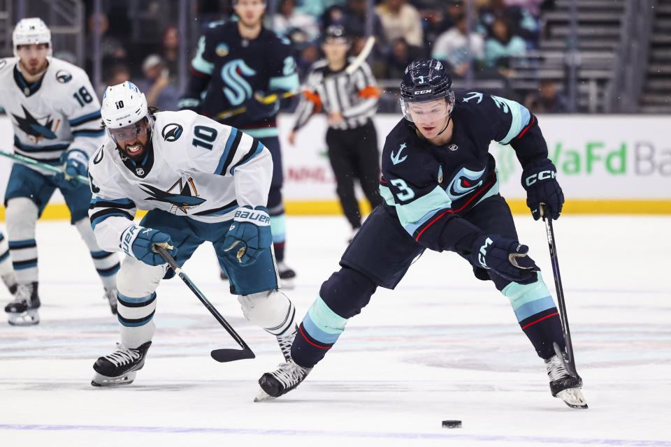 Seattle Kraken defenseman Will Borgen cuts around San Jose Sharks left wing Anthony Duclair during the first period of an NHL hockey game Wednesday, Nov. 22, 2023, in Seattle. (AP Photo/Maddy Grassy)