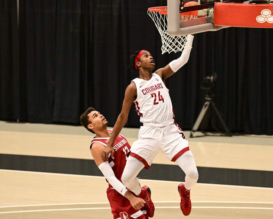 Washington State guard Noah Williams (24) attempts a layup next to Stanford forward Oscar da Silva (13) during the first half of an NCAA college basketball game, Saturday, Feb. 20, 2021, in Pullman, Wash. (AP Photo/Pete Caster)