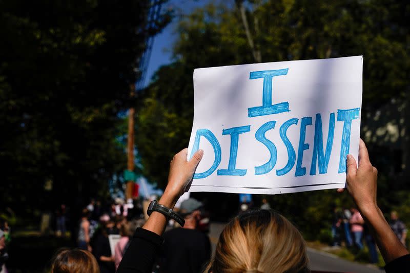 Protesters gather outside the home of US Senate Majority Leader Mitch McConnel in Louisville