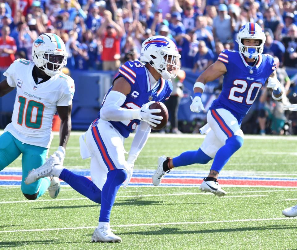 Oct 1, 2023; Orchard Park, New York, USA; Buffalo Bills safety Micah Hyde (23) returns an interception in front of Miami Dolphins wide receiver Tyreek Hill (10) and safety Taylor Rapp (20) in the third quarter at Highmark Stadium. Mandatory Credit: Mark Konezny-USA TODAY Sports