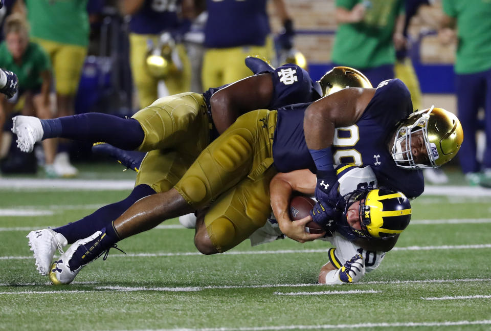 Notre Dame defensive lineman Jerry Tillery (99) tackles Michigan quarterback Dylan McCaffrey (10) in the second half of an NCAA football game in South Bend, Ind., Saturday, Sept. 1, 2018. Notre Dame won 24-17. (AP Photo/Paul Sancya)