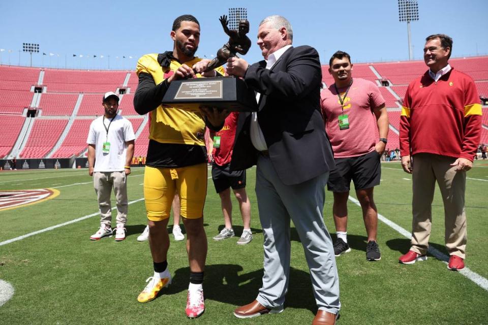 USC quarterback Caleb Williams receives the Heisman Trophy during the Trojans’ spring game.