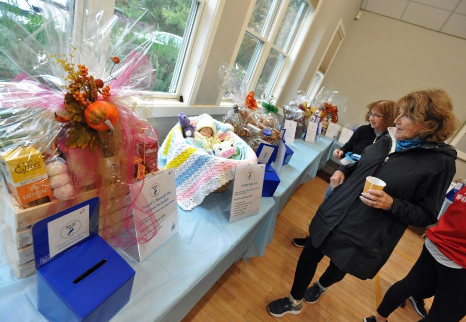 Walkers check out the raffle prizes during the Milton Council on Aging's Fit for Life Walk hosted by Milton Boot Camp, Saturday, Oct. 1, 2022.