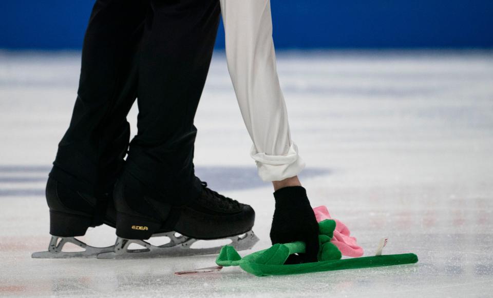 Philip Baker collects a gift off the ice from a fan after his performance during the Junior Men Free Skate Competition in the 2022 Toyota U.S. Figure Skating Championships at Bridgestone Arena Wednesday, Jan. 5, 2022 in Nashville, Tenn. 