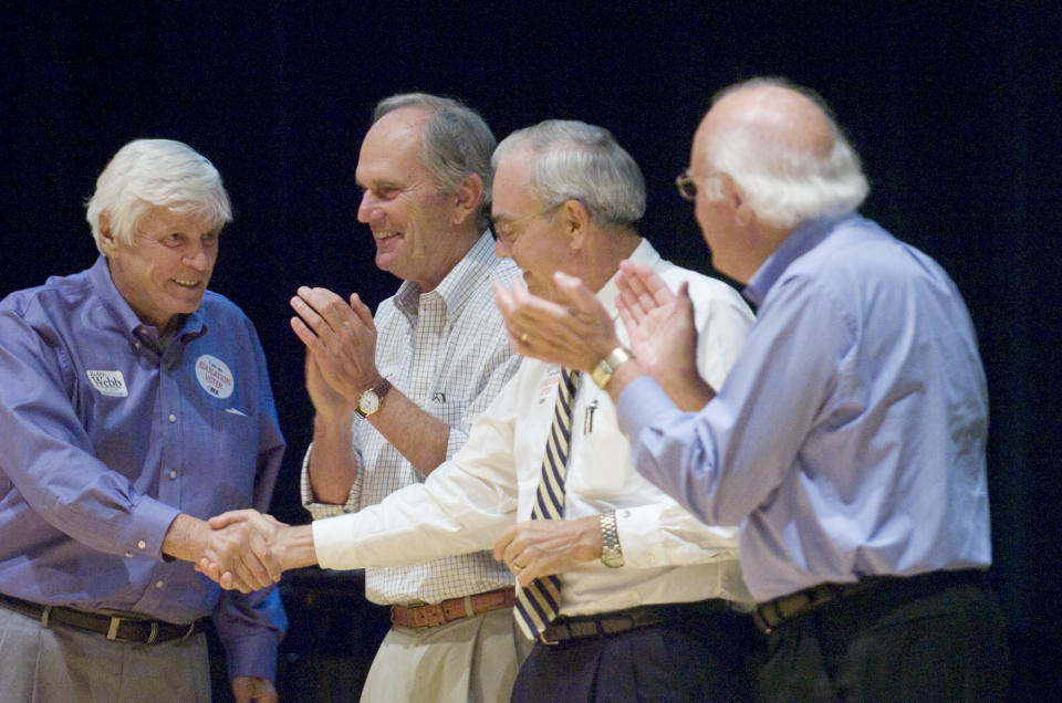 FILE - Former Kentucky Gov. John Y. Brown, left, shakes hands with fellow former Gov. Paul Patton, as two other former state chief executives, Brereton Jones and Julian Carroll look on, Aug. 22, 2009, in Raceland, Ky. Brown Jr., who became Kentucky’s governor after building empires in business and sports, has died, his family said in a release Tuesday, Nov. 22, 2022. He was 88. (John Flavell/The Daily Independent via AP, File)