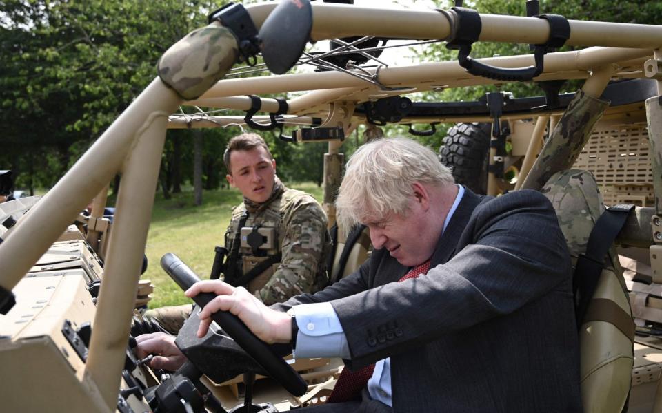 Boris impresses the troops with his driving skills... maybe - AFP