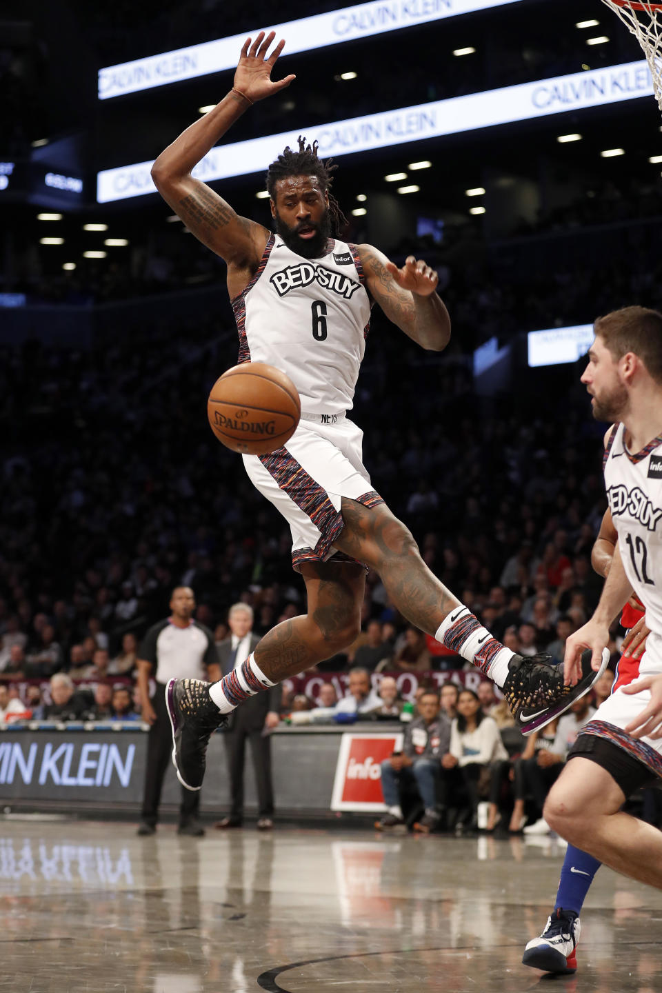 Brooklyn Nets guard Spencer Dinwiddie (8) leaps for the ball during the second quarter of an NBA basketball game against the Philadelphia 76ers at Barclays Center, Sunday, Dec. 15, 2019, in New York. (AP Photo/Michael Owens)
