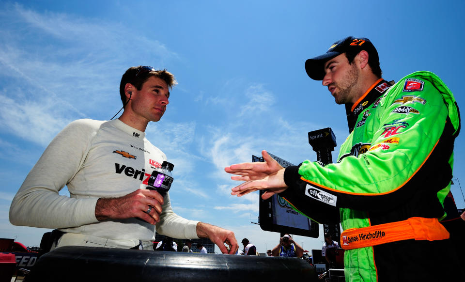 FORT WORTH, TX - JUNE 08: Will Power of Australia, driver of the #12 Verizon Team Penske Chevrolet Dallara, talks to James Hinchcliffe of Canada, driver of the #27 Team GoDaddy.com Chevrolet Dallara, during practice for the IZOD IndyCar Series Firestone 550 at Texas Motor Speedway on June 8, 2012 in Fort Worth, Texas. (Photo by Robert Laberge/Getty Images for Texas Motor Speedway)