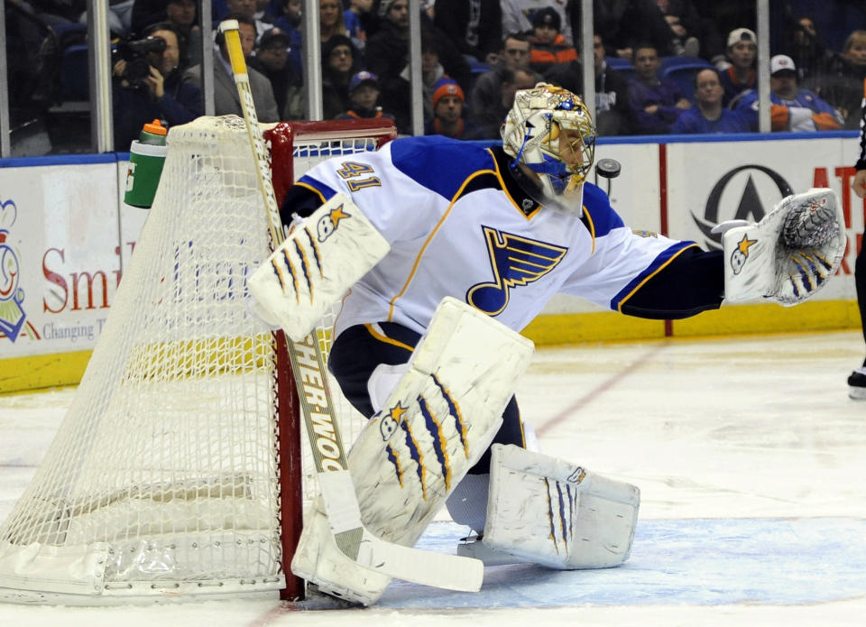 FILE - In this Jan 25, 2014, file photo, St. Louis Blues goalie Jaroslav Halak blocks a shot in the second period of an NHL hockey game against the New York Islanders in Uniondale, N.Y. The Buffalo Sabres traded star goalie Ryan Miller and captain Steve Ott to the Blues on Friday, Feb. 28, 2014, for Halak, forward Chris Stewart, prospect William Carrier, a 2015 first-round pick and a 2016 third-round pick. (AP Photo/Kathy Kmonicek, File)