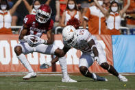 Oklahoma wide receiver Charleston Rambo (14) catches a pass in front of Texas defensive back Chris Brown (15) during an NCAA college football game in Dallas, Saturday, Oct. 10, 2020. (AP Photo/Michael Ainsworth)