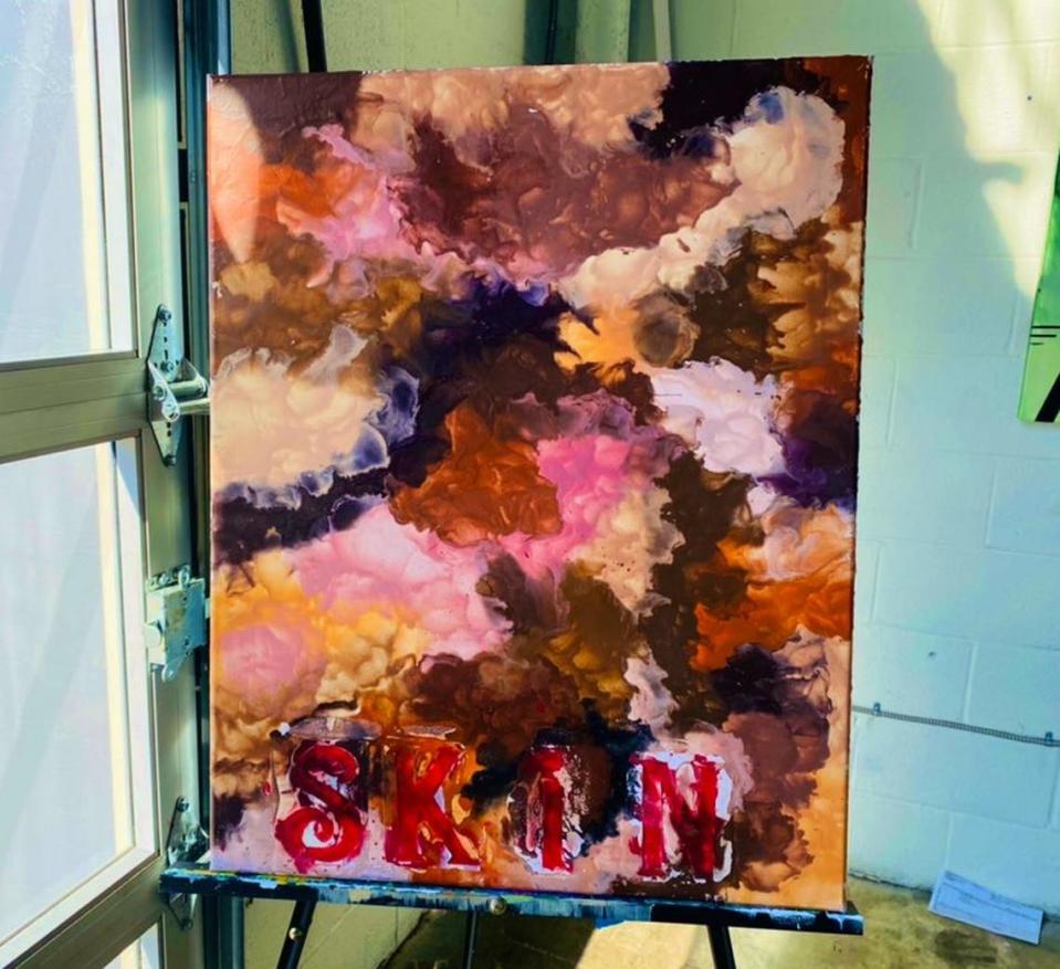 This piece, called “SKIN.,” was painted by Arelys Ripoll. She said it’s a mesh of all skin tones from all over the world, “showing that with unity life can be beautiful.”