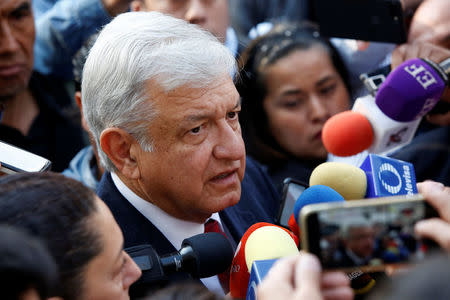 Leftist front-runner Andres Manuel Lopez Obrador is interviewed by journalists after a floral tribute to mark the 212th anniversary of the birth of president Benito Juarez, at the Hemiciclo a Juarez monument in Mexico City, Mexico March 21, 2018. REUTERS/Ginnette Riquelme