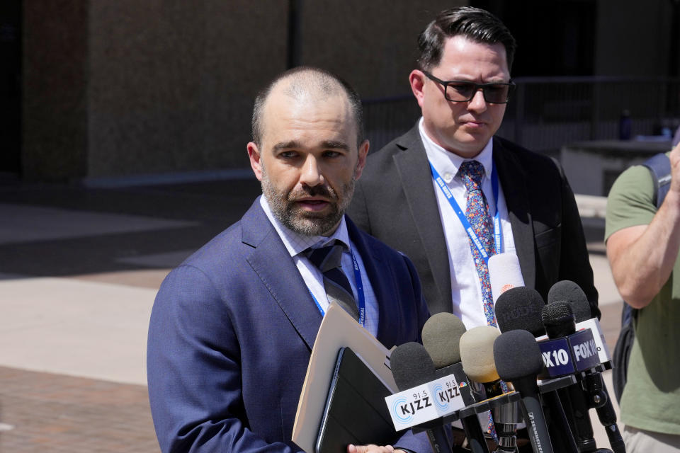 Assistant Attorney General Nicholas Klingerman speaks outside Maricopa County Superior Court after the arraignment at least 12 people on several charges in their role in an effort to overturn Donald Trump's 2020 election loss in Arizona to Joe Biden Tuesday, May 21, 2024, in Phoenix. (AP Photo/Ross D. Franklin)