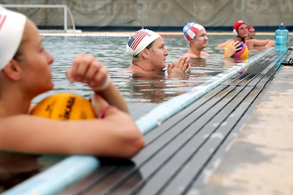 Melissa Seidemann, second from left, and other players listen to coach Adam Krikorian.