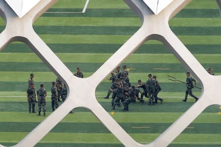 FILE PHOTO: Chinese soldiers practice on the grounds of the Shenzhen Bay Sports Center in Shenzhen across the bay from Hong Kong