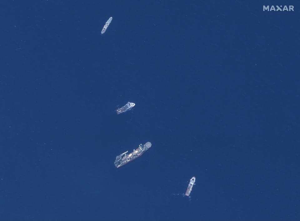 In this satellite image provided by Maxar Technologies, from top to bottom, the vessels L'Atalante, Horizon Arctic, Deep Energy, and Skandi Vinland search for the missing submersible Titan, Thursday June 22, 2023 in the Atlantic Ocean. (Satellite image ©2023 Maxar Technologies via AP)