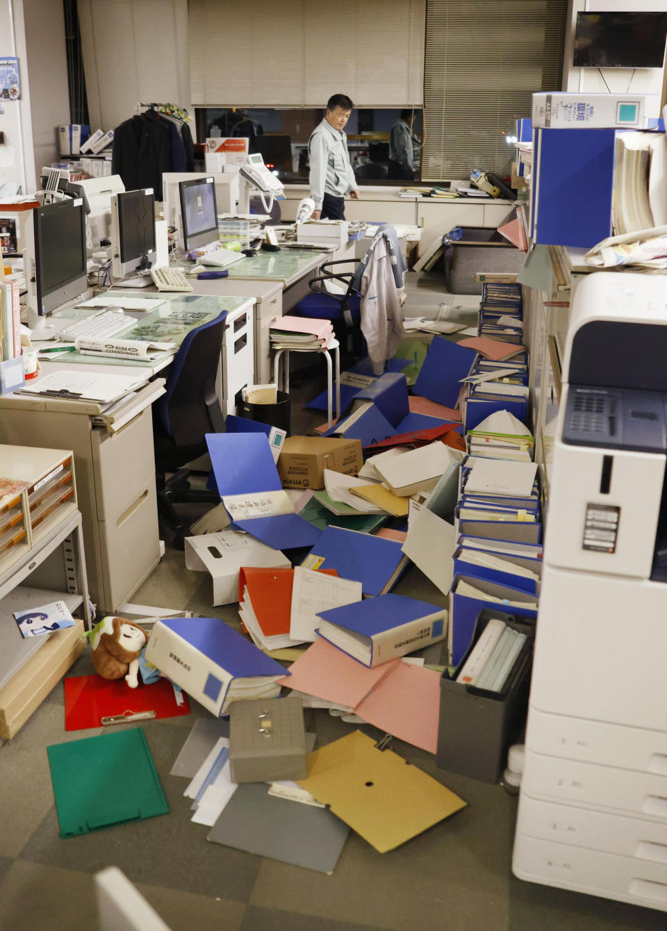 Files are scattered on the floor following an earthquake at a town office in Hironomachi, Fukushima prefecture, northeastern Japan Saturday, Feb. 13, 2021. A strong earthquake hit off the coast of northeastern Japan late Saturday, shaking Fukushima, Miyagi and other areas, but there was no threat of a tsunami, officials said. (Naoya Osato/Kyodo News via AP)