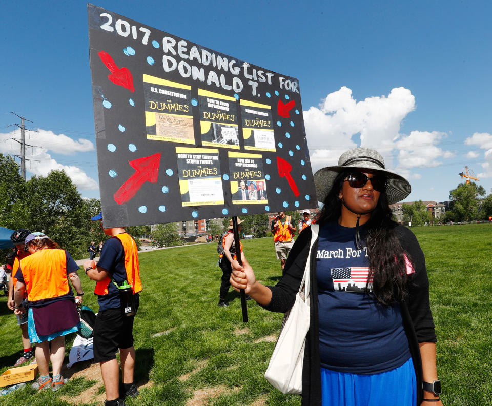 <p>Rissa Khan of Denver holds up a sign during a protest against the polices of President Donald Trump on Saturday, June 3, 2017, in downtown Denver. (Photo: David Zalubowski/AP) </p>